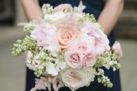12 navy bridesmaid’s dress and a blush bouquet