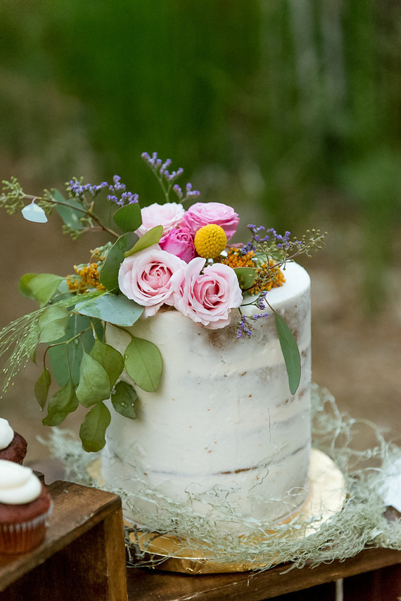 The cake was a trendy slightly frosted one topped with fresh flowers
