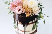 13 dirty frosted tall wedding cake with dark chocolate drip, macarons and ivory flowers