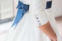 13 navy buttons and a sash with a bow