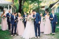 15 bridesmaids in blush maxi dresses and groomsmen in navy suits