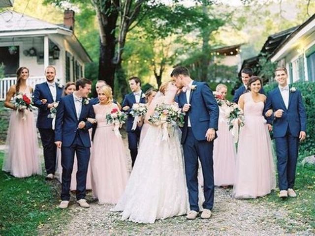 bridesmaids in blush maxi dresses and groomsmen in navy suits