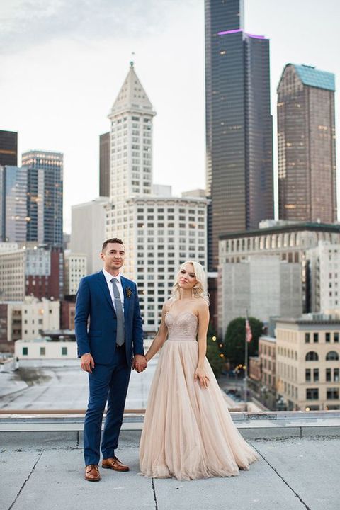 the groom in navy and the bride in blush