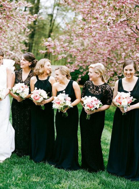 bridesmaids in black with blush bouquets
