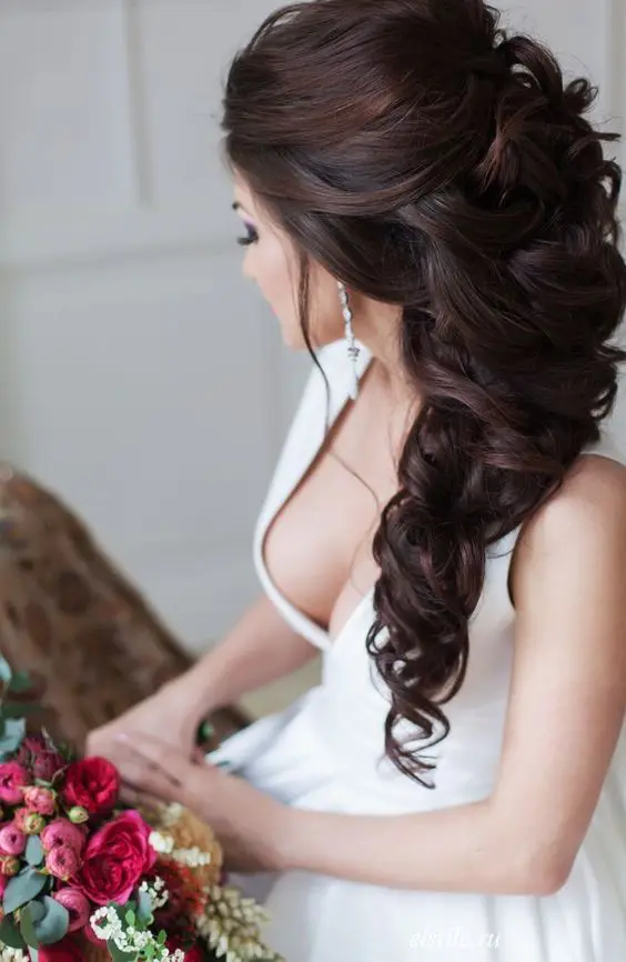 a glam braided and curly hairstyle with a lot of volume looks very girlish and quite formal, great for a formal bride