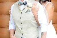 grey pants, an ivory vest, a white shirt and a bow tie plus a belt for a classy and comfortable bridal look at the wedding