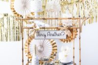 18 fringe backdrop and paper fans with metallic touches