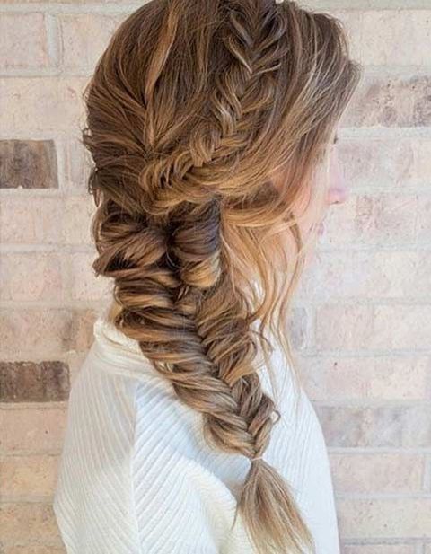 a braided halo on one side of the head going down as a thick side braid are a cool combo for a more relaxed or boho wedding