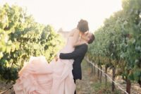 18 the groom in black, and the bride in blush rose-ruffle gown