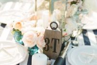 19 blush and ivory flowers on a striped navy and white tablecloth