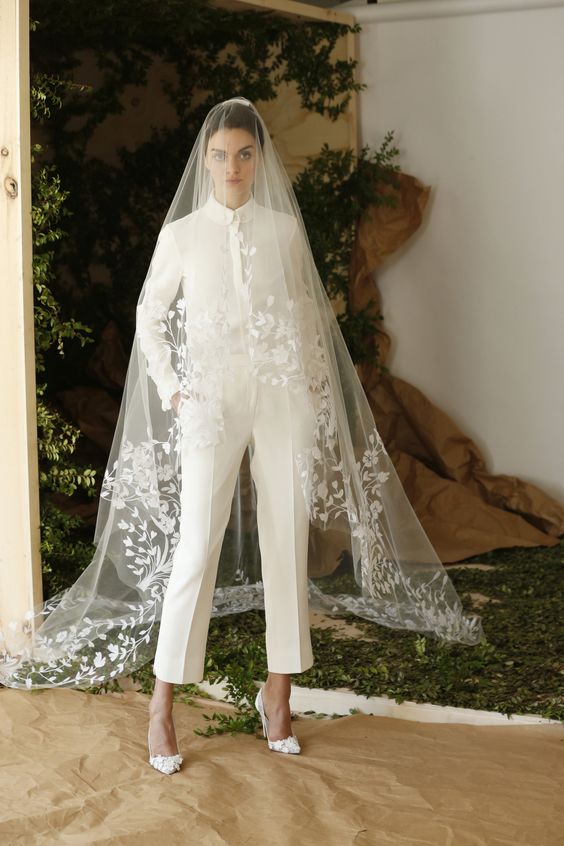 cropped ivory pants and a shirt, white floral heels and a long veil with lace applique create a bold and chic modern bridal look