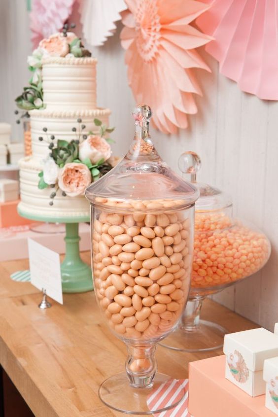 peach candies, flowers and paper decor, a mint cake stand