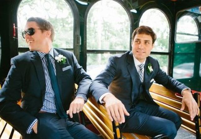 same navy suits, a shirt that matches the other groom’s tie