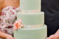 22 a mint wedding cake with ivory ribbon and fresh peach flowers