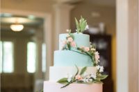 23 a wedding cake with two peach and two mint layers topped with flowers
