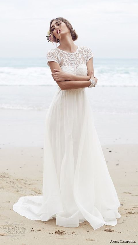 a lace bodice wwith short sleeves and an illusion neckline, an airy skirt