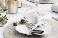 27 round silver placemats echo with mercury glass candle holders
