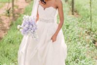 27 sweetheart wedding dress with a flowing skirt and an embellished sash