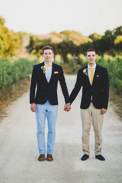 these grooms chose the same black jackets but different pants, shoes and ties