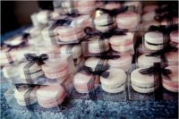 28 blush and ivory macarons tied with black ribbon