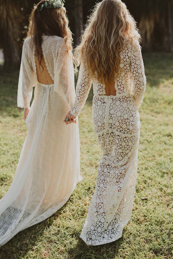 boho chic bridal dresses with statement backs in the same style for both brides at a boho wedding