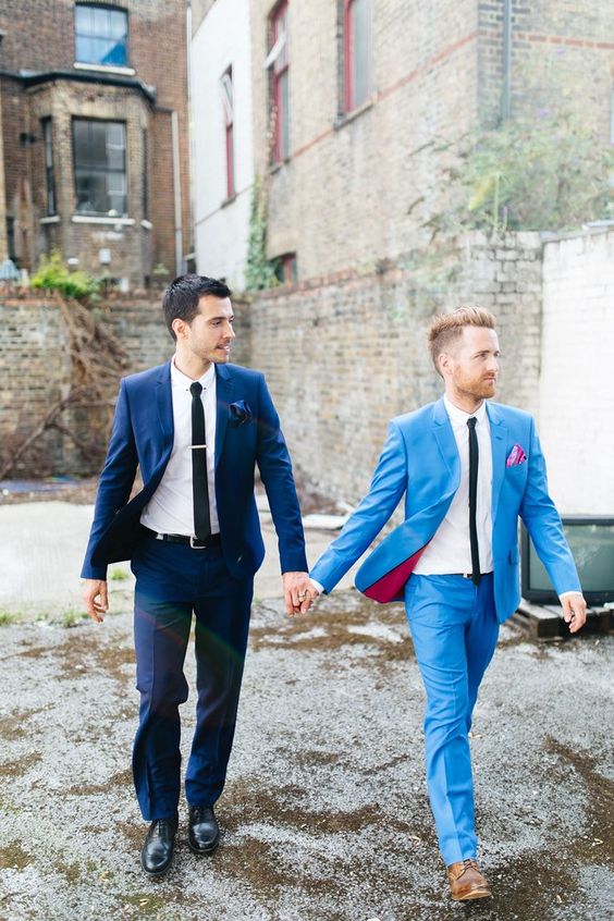 grooms in the same suits in shades of blue   bold light blue and navy