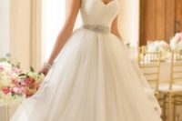 29 ruched bodice, an embellished sash and a layered tulle skirt