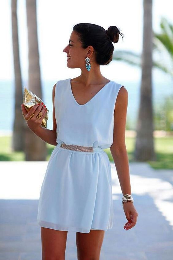white mini dress with a V-neck and accessories that make the whole outfit