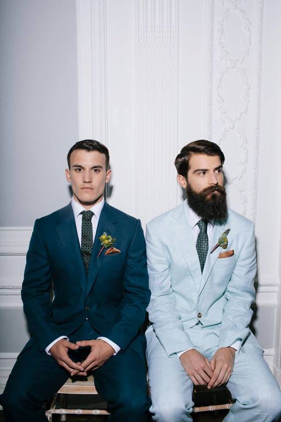 grooms in the same suits of different shades of blue and wwith different ties
