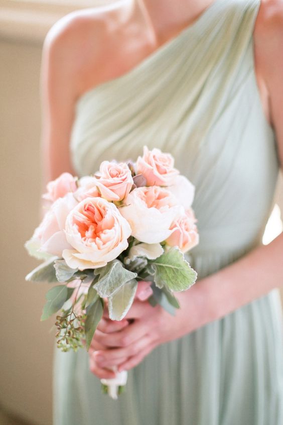 mint bridesmaid's dress and a delicate peach and mint bouquet