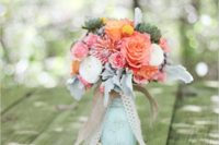 34 mint mason jar centerpiece with peach and pink flowers