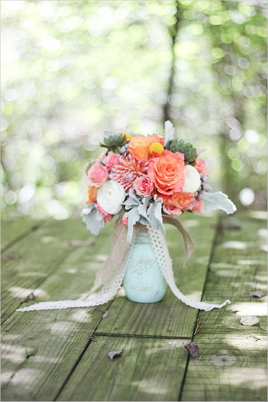 mint mason jar centerpiece with peach and pink flowers