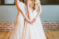 a strapless ivory wedding dress and a blush lace applique wedding gown create a very romantic and delicate couple look