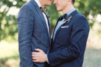 36 a navy suit and a blue shirt for one groom, a slate grey suit with a neutral bow tie on the second groom