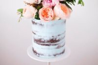 37 mint dirty frosted wedding cake with a lush floral topper