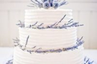 40 three-tier wedding cake topped with lavender and thistle