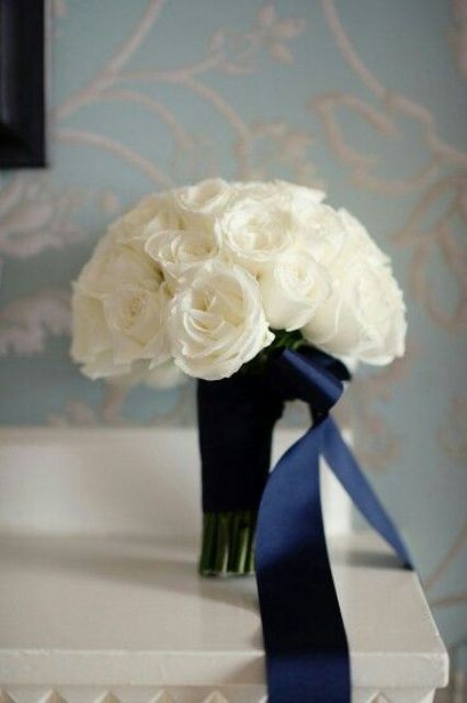 elegant bouquet of white roses and navy ribbon