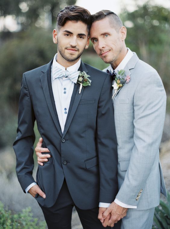 grooms in shades of grey - one in a graphite grey suit, the second in a dove grey suit