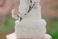 42 square white wedding cake with decorative blooms