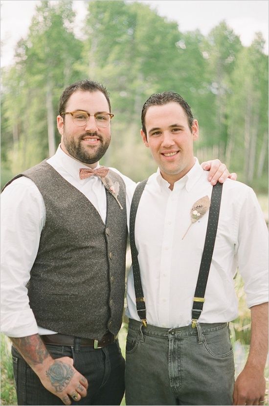 one groom in a tweed vest and a bow tie, the second just in suspenders