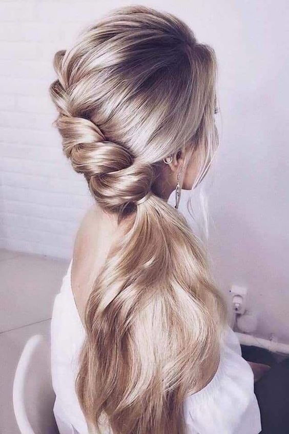 a beautiful and delicate braid going into a side ponytail, with a volume on top is a lovely idea for a romantic bride