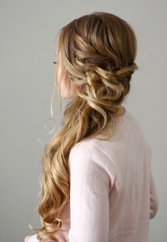 a beautiful side-swept Dutch braid with a twsited and wrapped touch and waves down plus face-framing hair