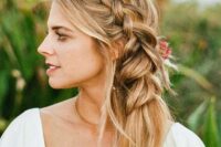 a beautiufl and romantic side braid into a ponytail, with face-framing waves is a stylish idea, accent it with fresh blooms