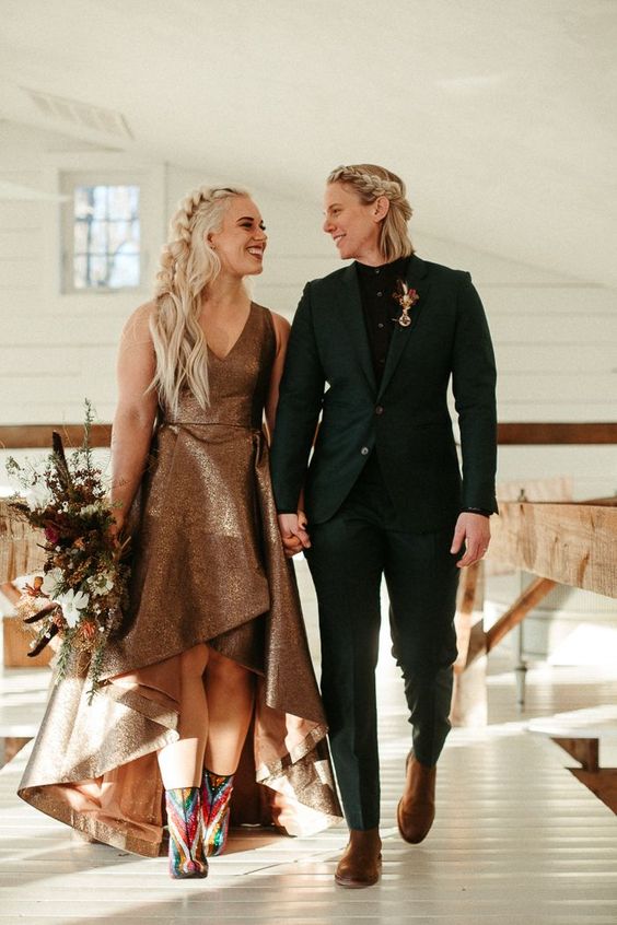 a black pantsuit, a black shirt, brown boots and a bold boutonniere, a dark copper high low wedding dress with a train for a fall boho wedding