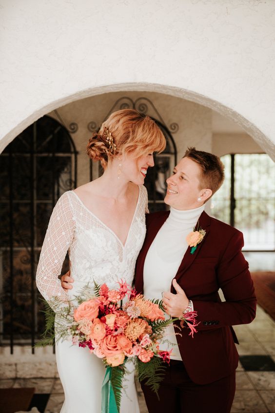 a burgundy pantsuit with a neutral turtleneck, a boho lace wedding dress with a plunging neckline and long sleeves