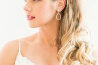 a chic side swept hairstyle with several braids on the sides, waves and curls is a lovely solution for a boho bride
