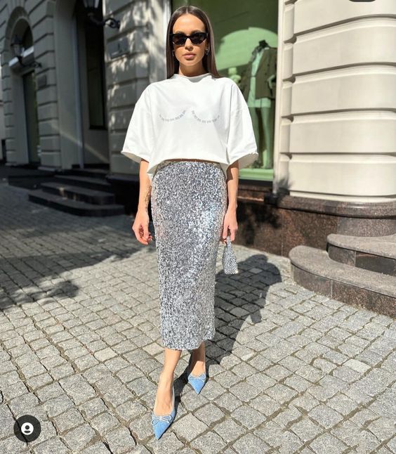 a classy bachelorette look with a white printed t-shirt, a silver sequin midi, light blue shoes and a silver bag