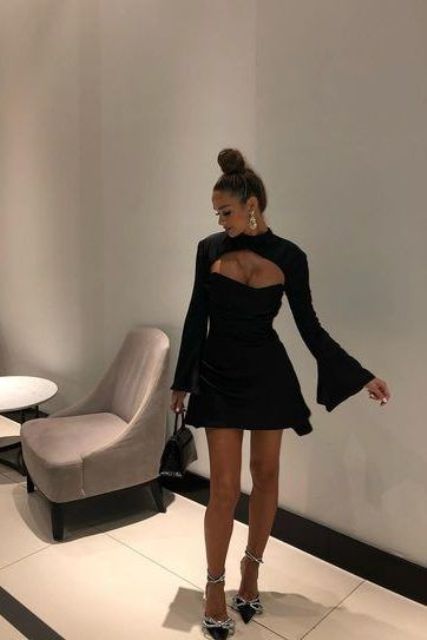 a classy black mini dress with a cutout neckline, flare sleeves, black embellished shoes, statement earrings and a mini bag