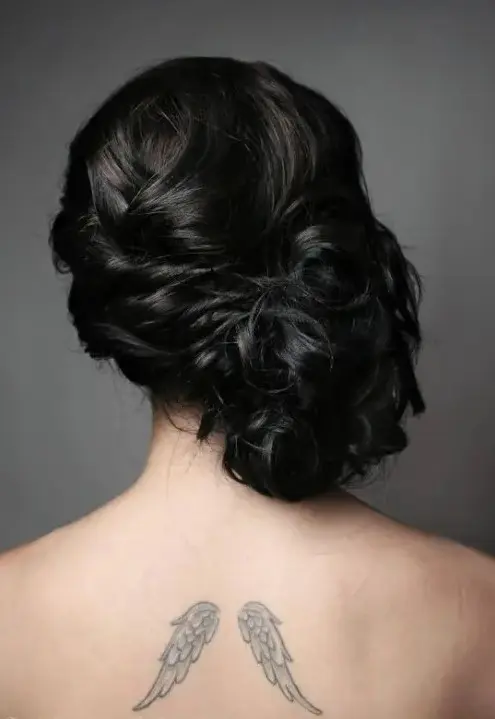 a curly twisted and wavy side updo with a volume on top for long hair and a romantic vintage bridal look