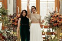 a dark green halter neckline jumpsuit, nude lace up shoes for one bride, a separate with a beaded crop top and a pleated skirt with a train for the second bride